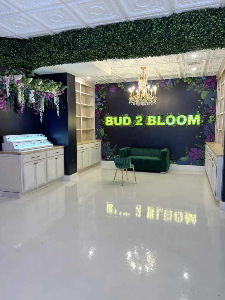 Full interior of Bud 2 Bloom cannabis boutique with floral decor and lounge seating