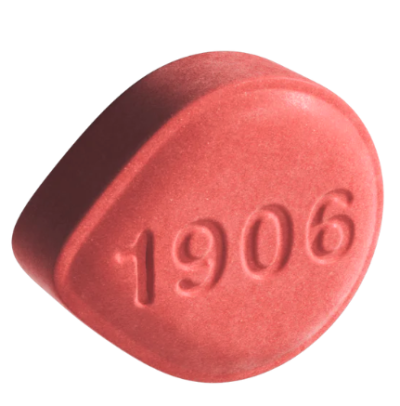 Close-up of a single 1906 Love Drops cannabis-infused herbal supplement pill.
